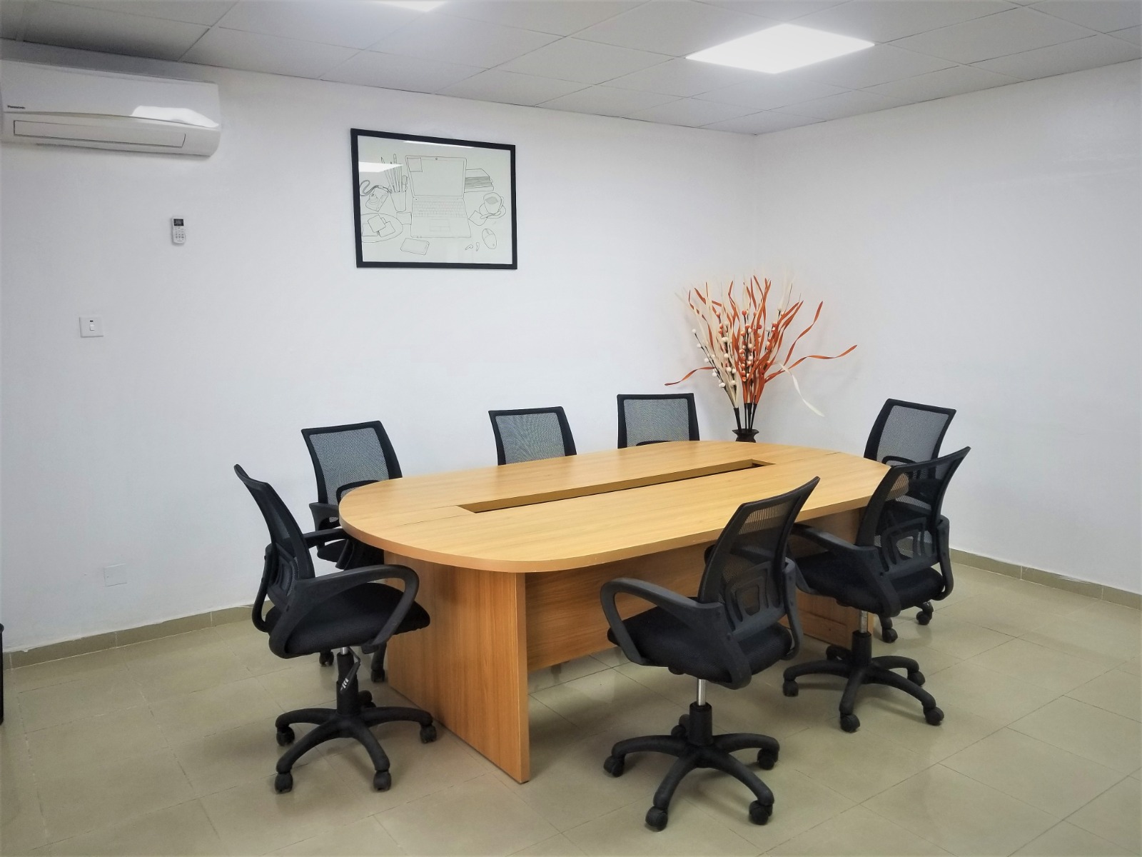 Meeting room with a large wood table and office chairs