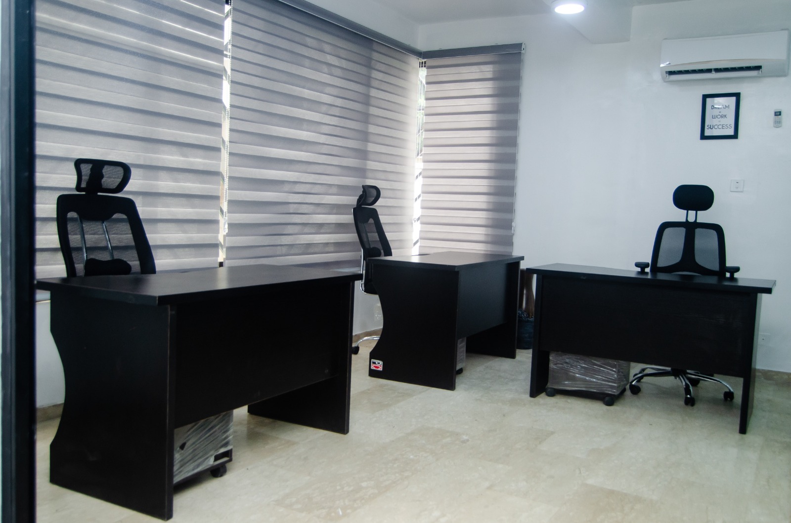 Shared office with desks and blinds